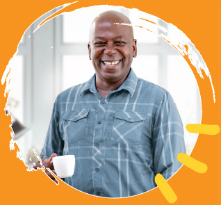 Man smiling holding a coffee mug