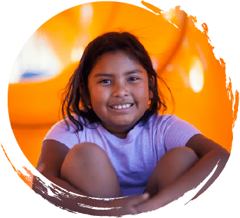 Slightly overweight child smiling on a playground